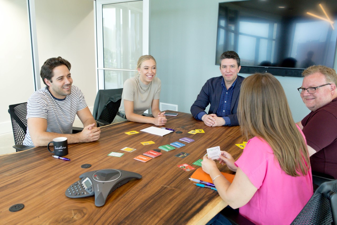 A group of game players sitting around the table.